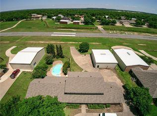 Aerial view showing runway relationship and property layout