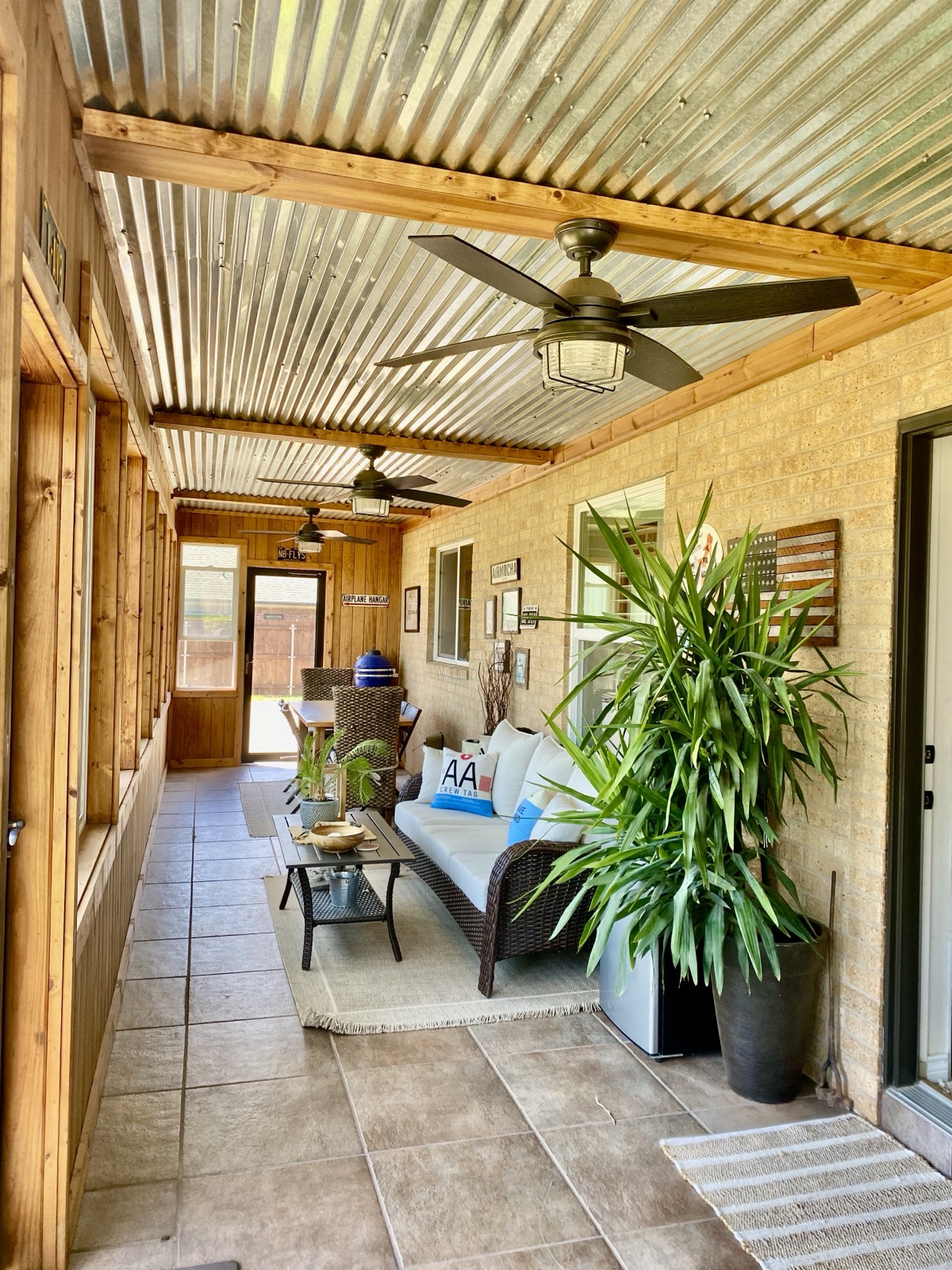 Enclosed back porch with corrugated ceiling and aviation signage
