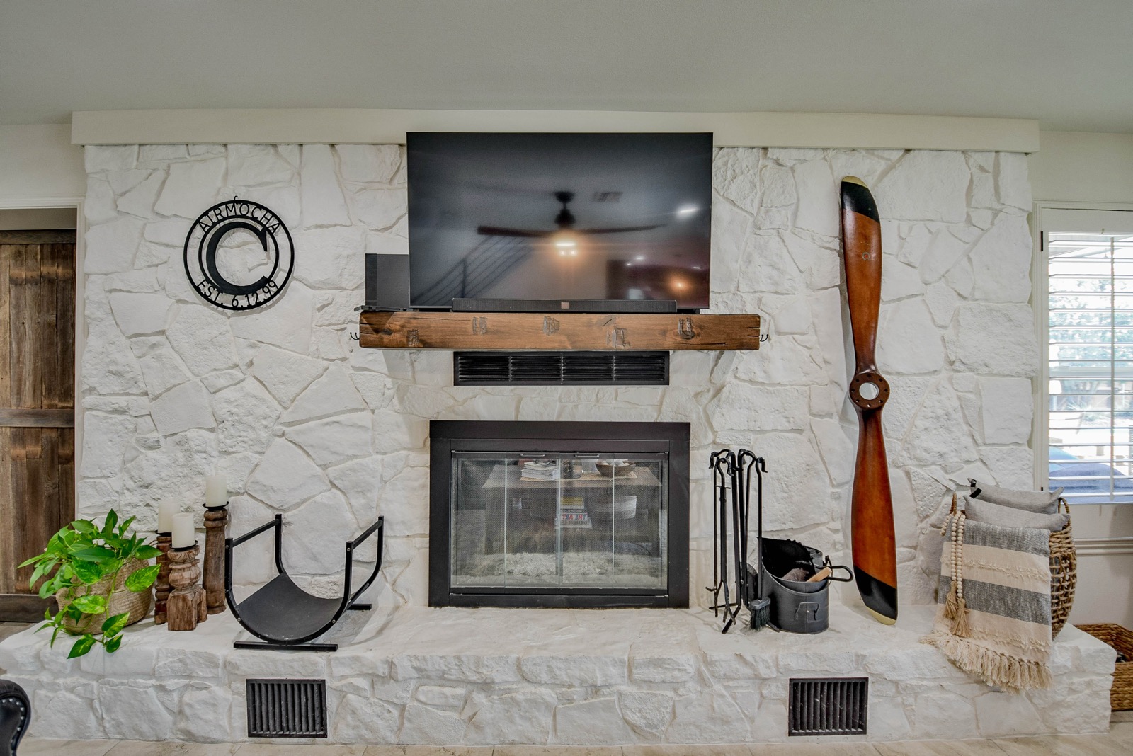 Stone fireplace with vintage wooden propeller, wood-burning